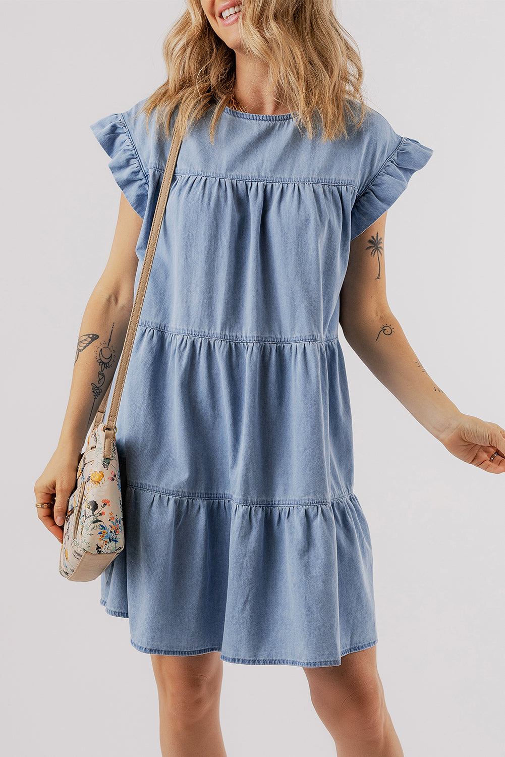 Beau Blue Ruffle Short Sleeve Tiered A-line Denim Dress displayed on a mannequin, showcasing its stylish design and ruffle sleeves.