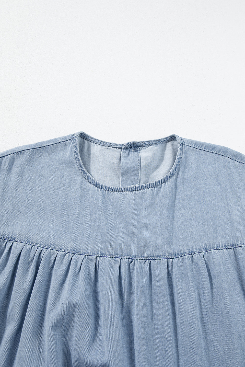 Beau Blue Ruffle Short Sleeve Tiered A-line Denim Dress displayed on a mannequin, showcasing its stylish design and ruffle sleeves.