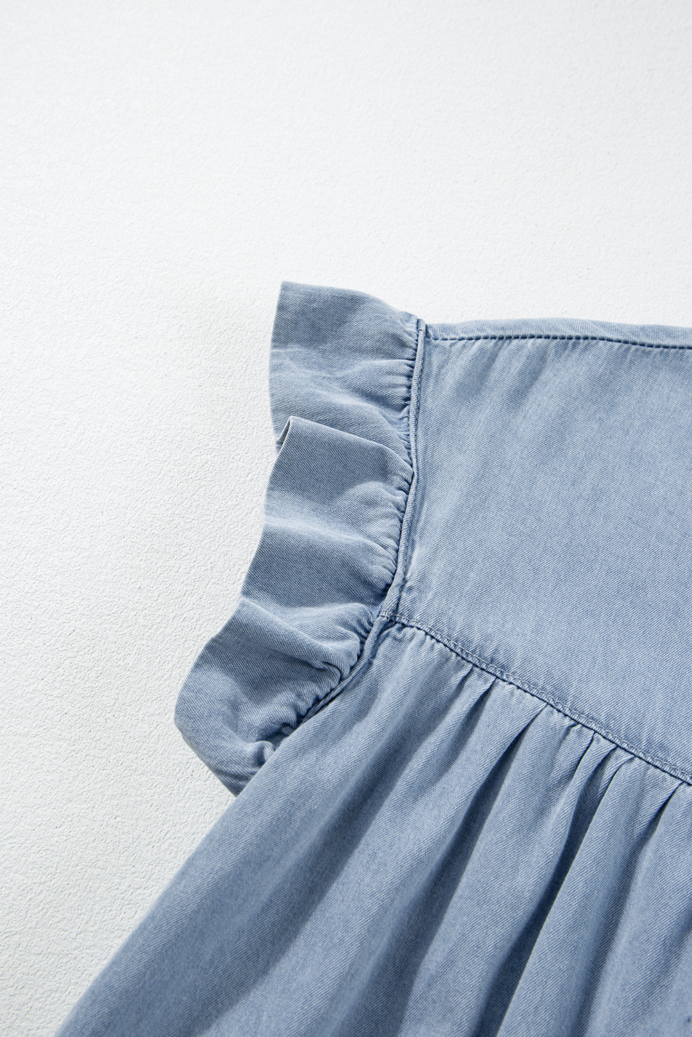 Beau Blue Ruffle Short Sleeve Tiered A-line Denim Dress displayed on a mannequin, showcasing its stylish design and ruffle sleeves.