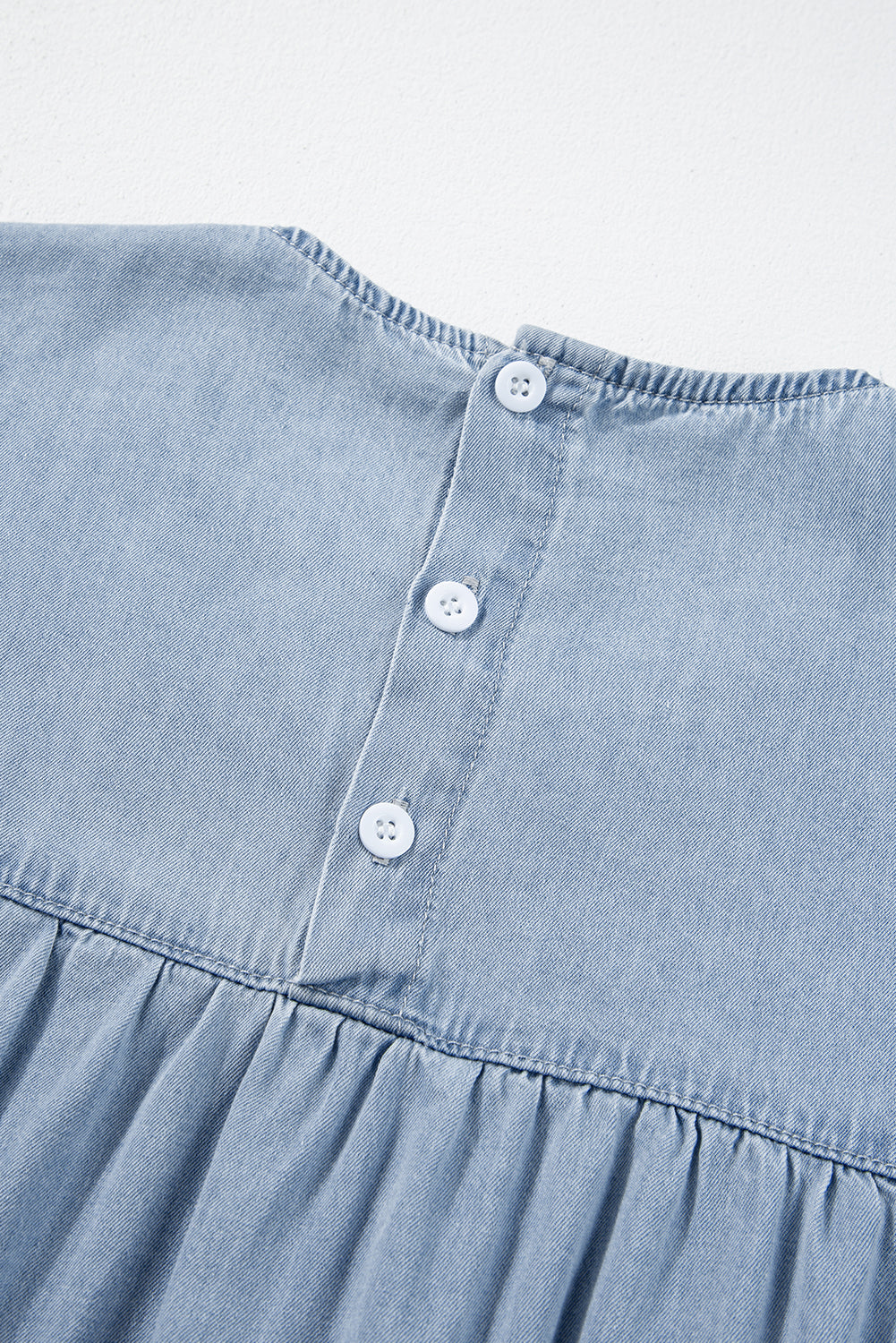 Beau Blue Ruffle Short Sleeve Tiered A-line Denim Dress displayed on a mannequin, showcasing its stylish design and ruffle sleeves.