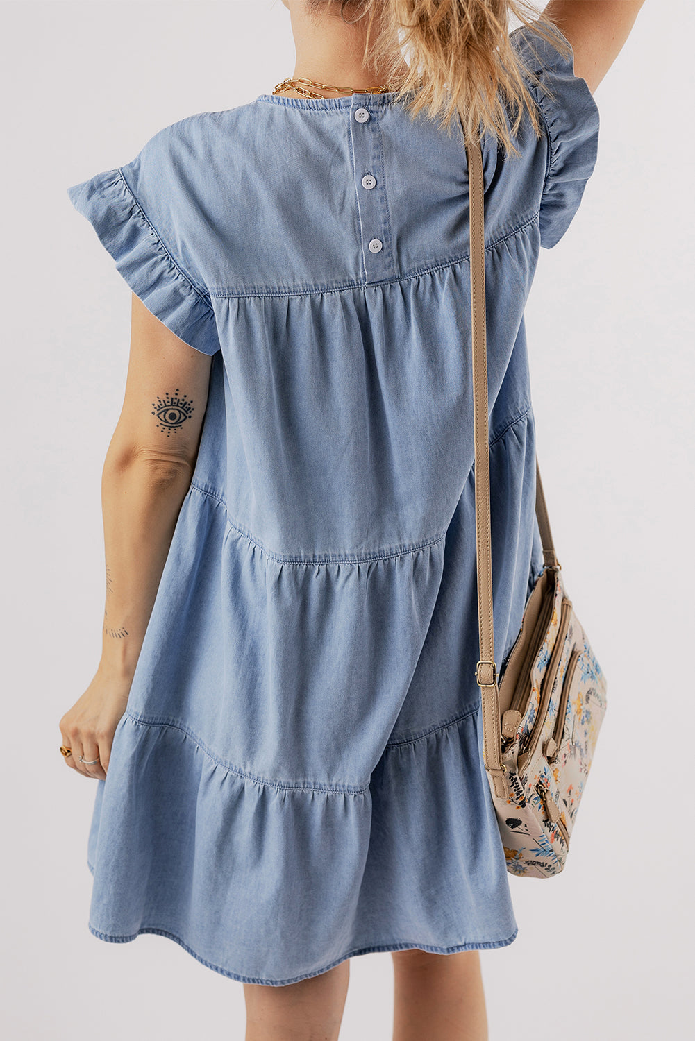 Beau Blue Ruffle Short Sleeve Tiered A-line Denim Dress displayed on a mannequin, showcasing its stylish design and ruffle sleeves.