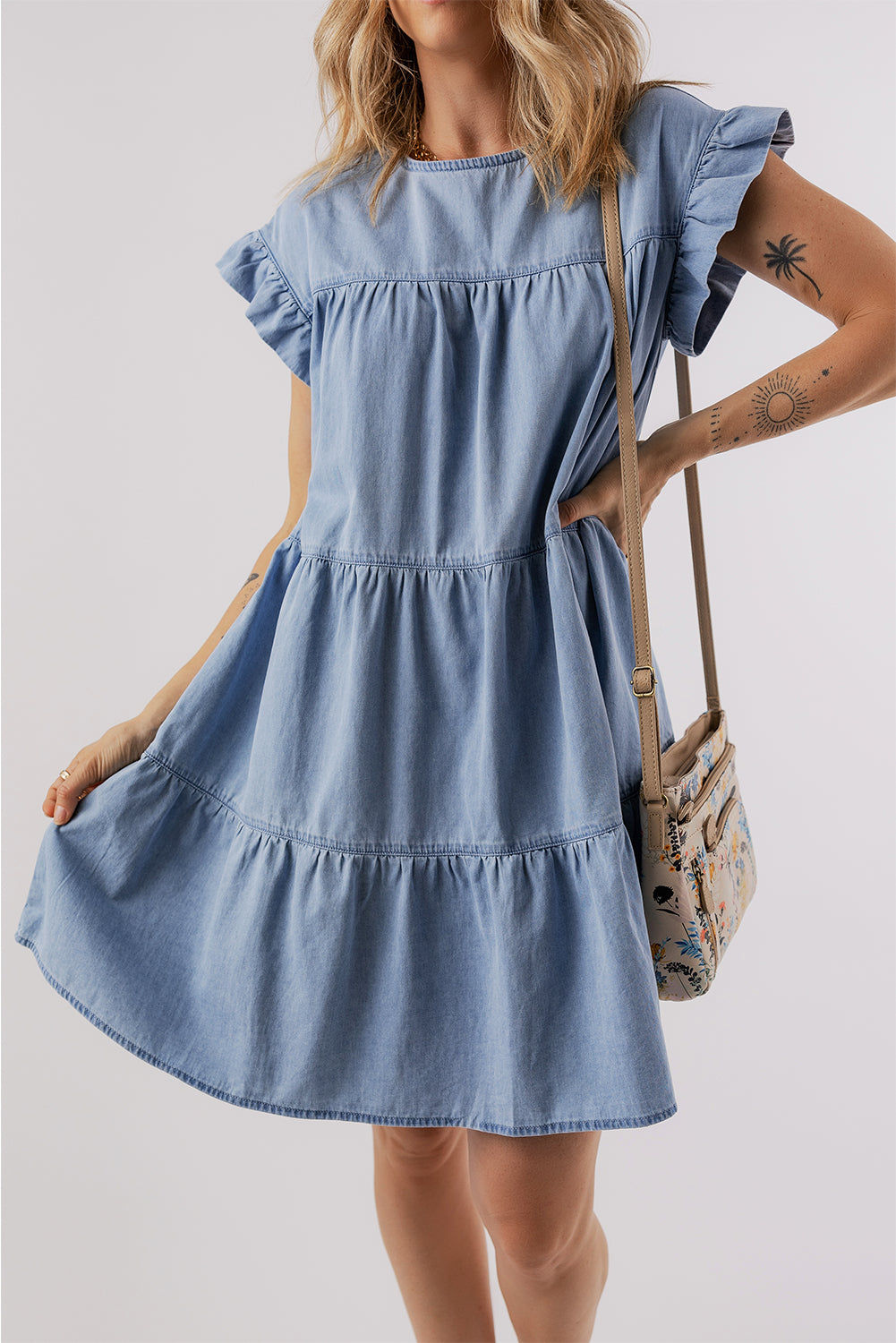 Beau Blue Ruffle Short Sleeve Tiered A-line Denim Dress displayed on a mannequin, showcasing its stylish design and ruffle sleeves.