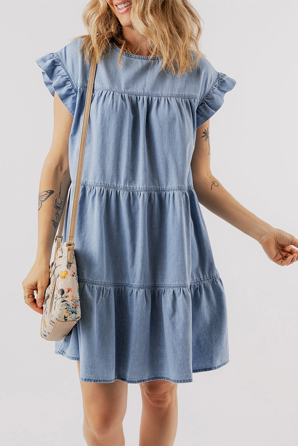 Beau Blue Ruffle Short Sleeve Tiered A-line Denim Dress displayed on a mannequin, showcasing its stylish design and ruffle sleeves.