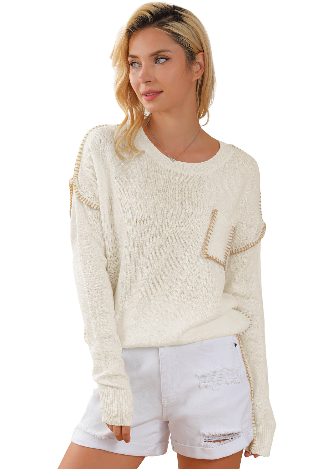 Beige sweater featuring exposed stitching, drop shoulder design, and a chest pocket, styled on a mannequin.