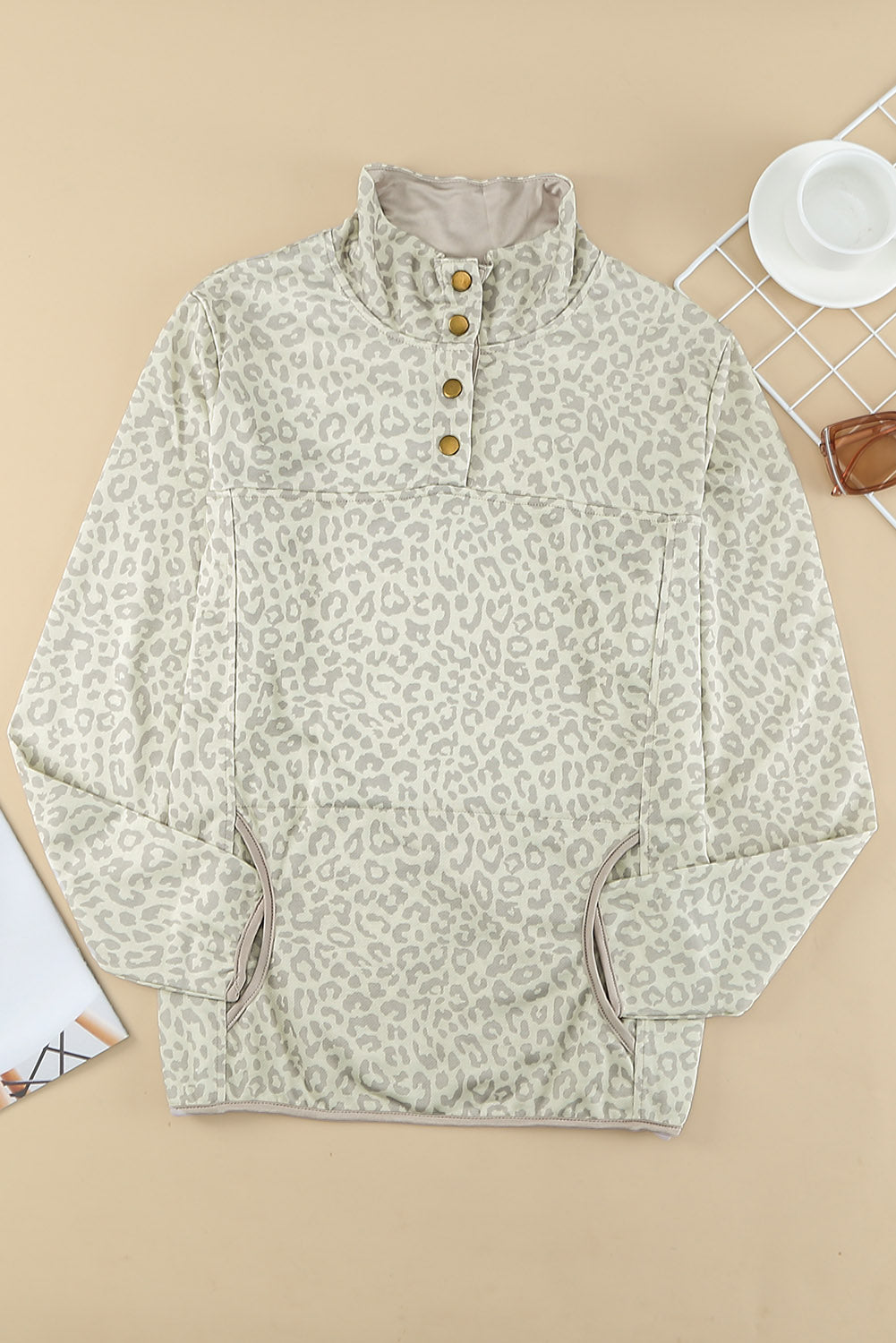 Beige lapel sweatshirt with leopard print, featuring a snap front and kangaroo pocket, perfect for casual wear.