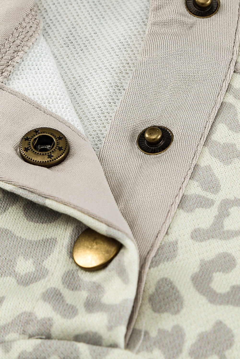 Beige lapel sweatshirt with leopard print, featuring a snap front and kangaroo pocket, perfect for casual wear.