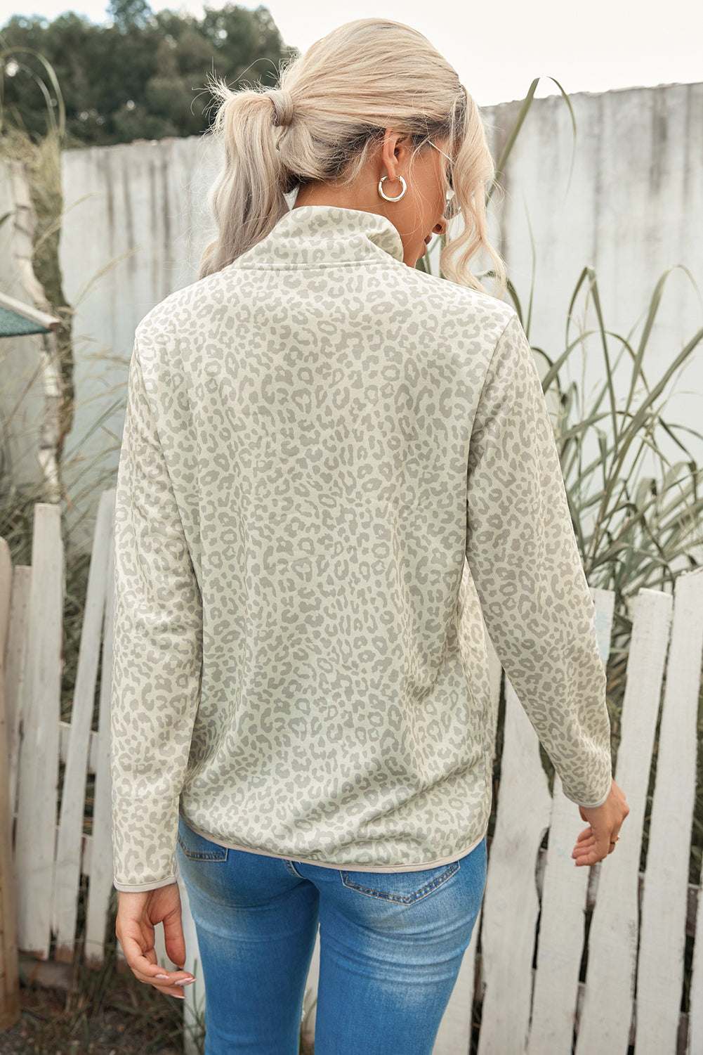 Beige lapel sweatshirt with leopard print, featuring a snap front and kangaroo pocket, perfect for casual wear.