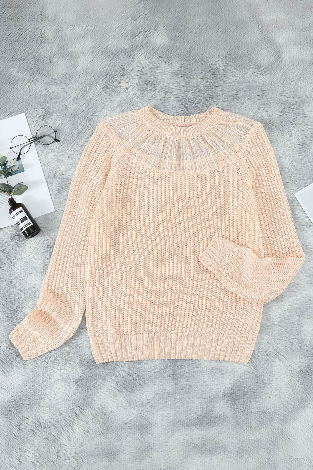 Beige knitted sweater featuring round neck and lace splicing details, perfect for stylish layering in chilly weather.