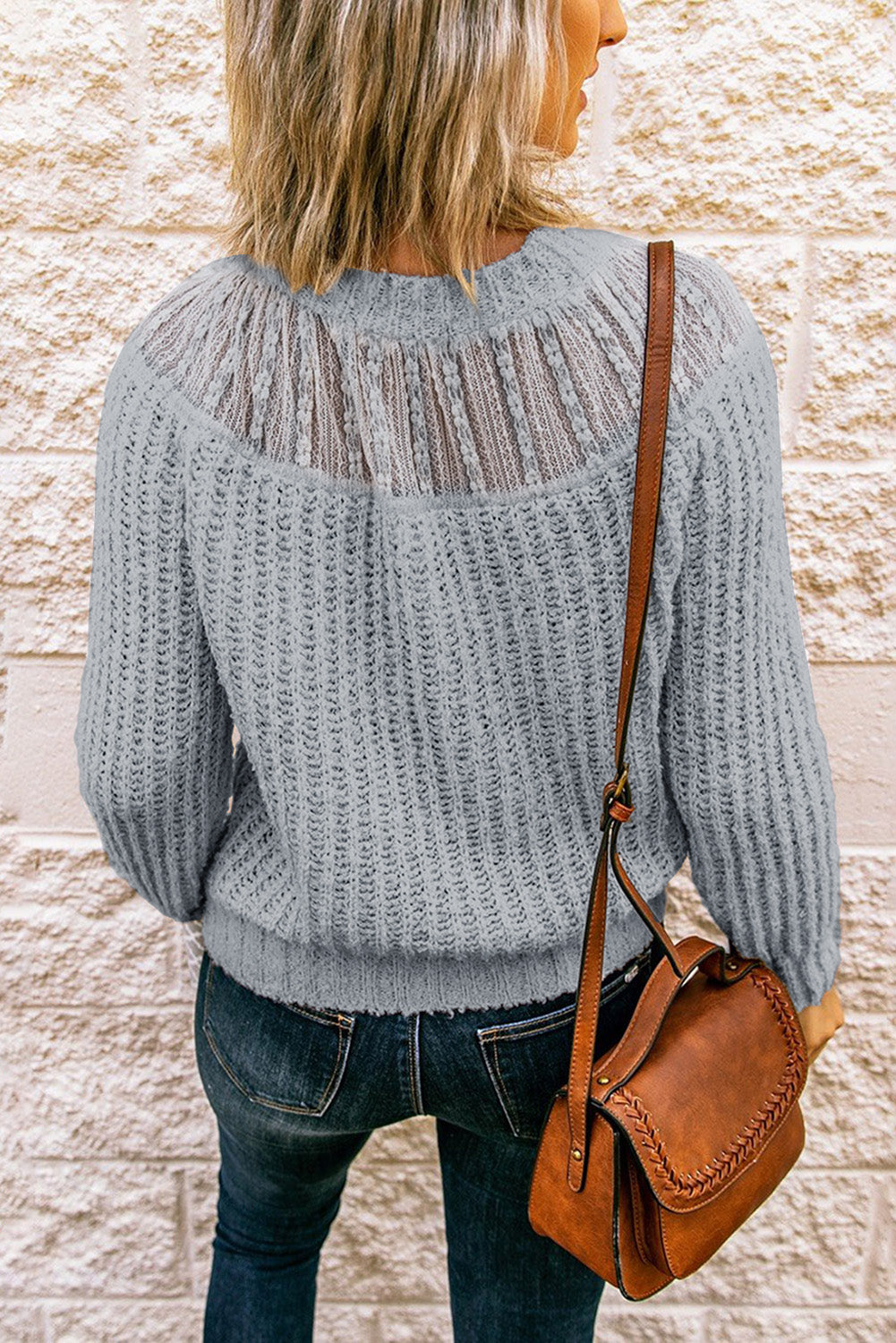 Beige knitted sweater featuring round neck and lace splicing details, perfect for stylish layering in chilly weather.