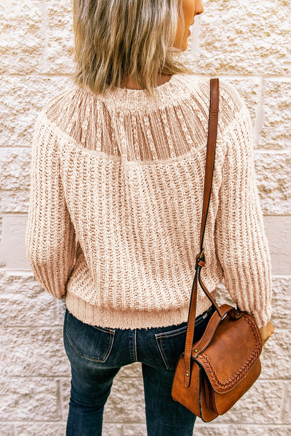 Beige knitted sweater featuring round neck and lace splicing details, perfect for stylish layering in chilly weather.