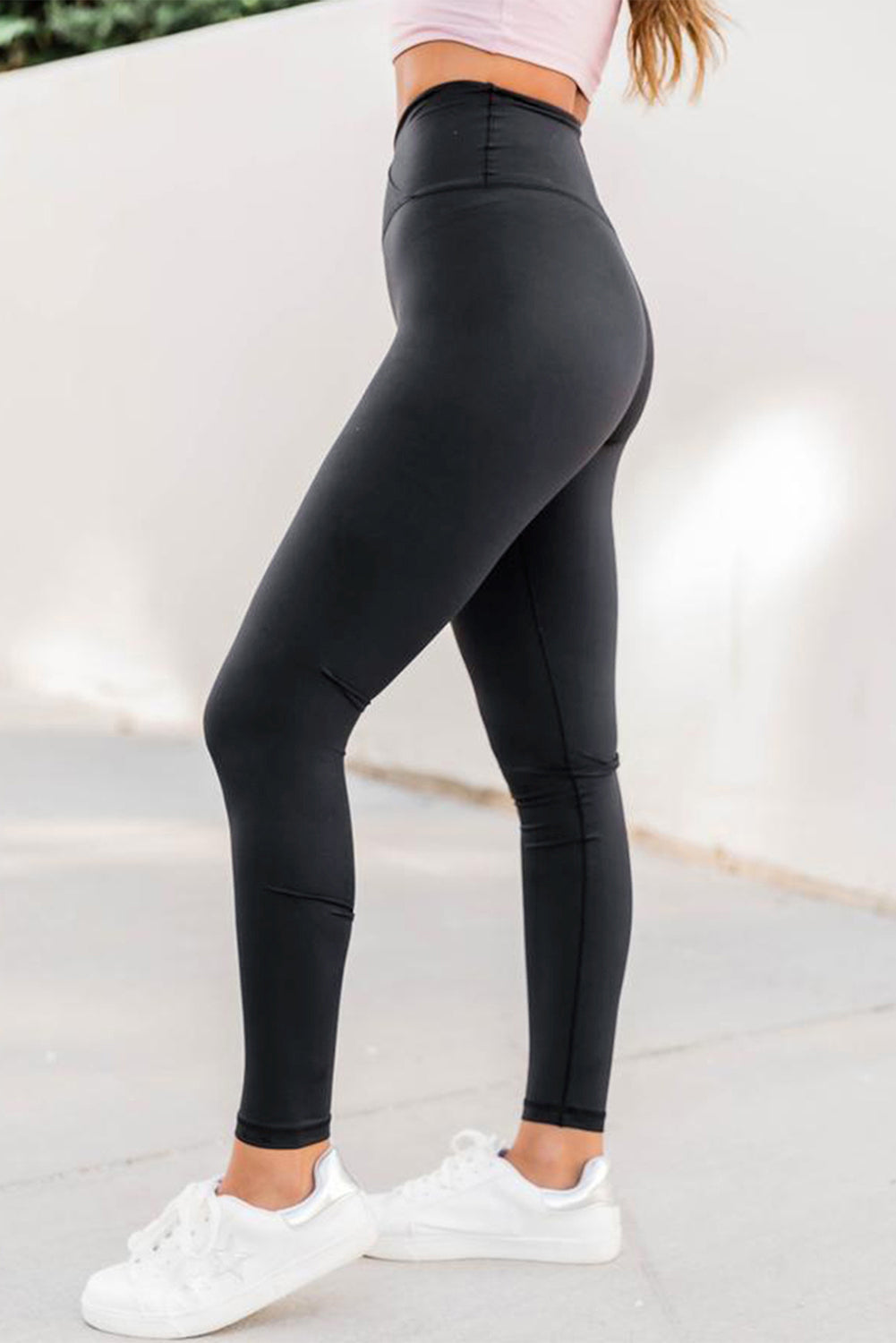 Black Arch Waist Sports Yoga Leggings featuring a high waist and crossed front design, perfect for workouts and casual wear.