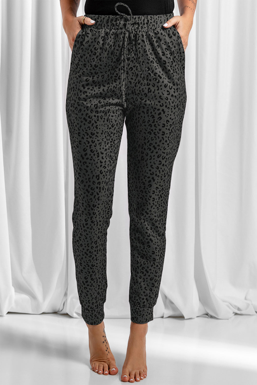 Black Breezy Leopard Joggers featuring a stylish leopard print and adjustable smocked waist, perfect for casual wear.