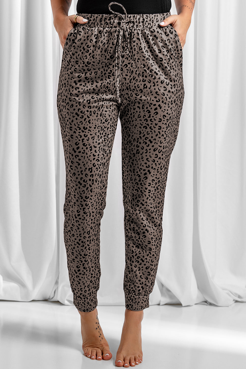 Black Breezy Leopard Joggers featuring a stylish leopard print and adjustable smocked waist, perfect for casual wear.