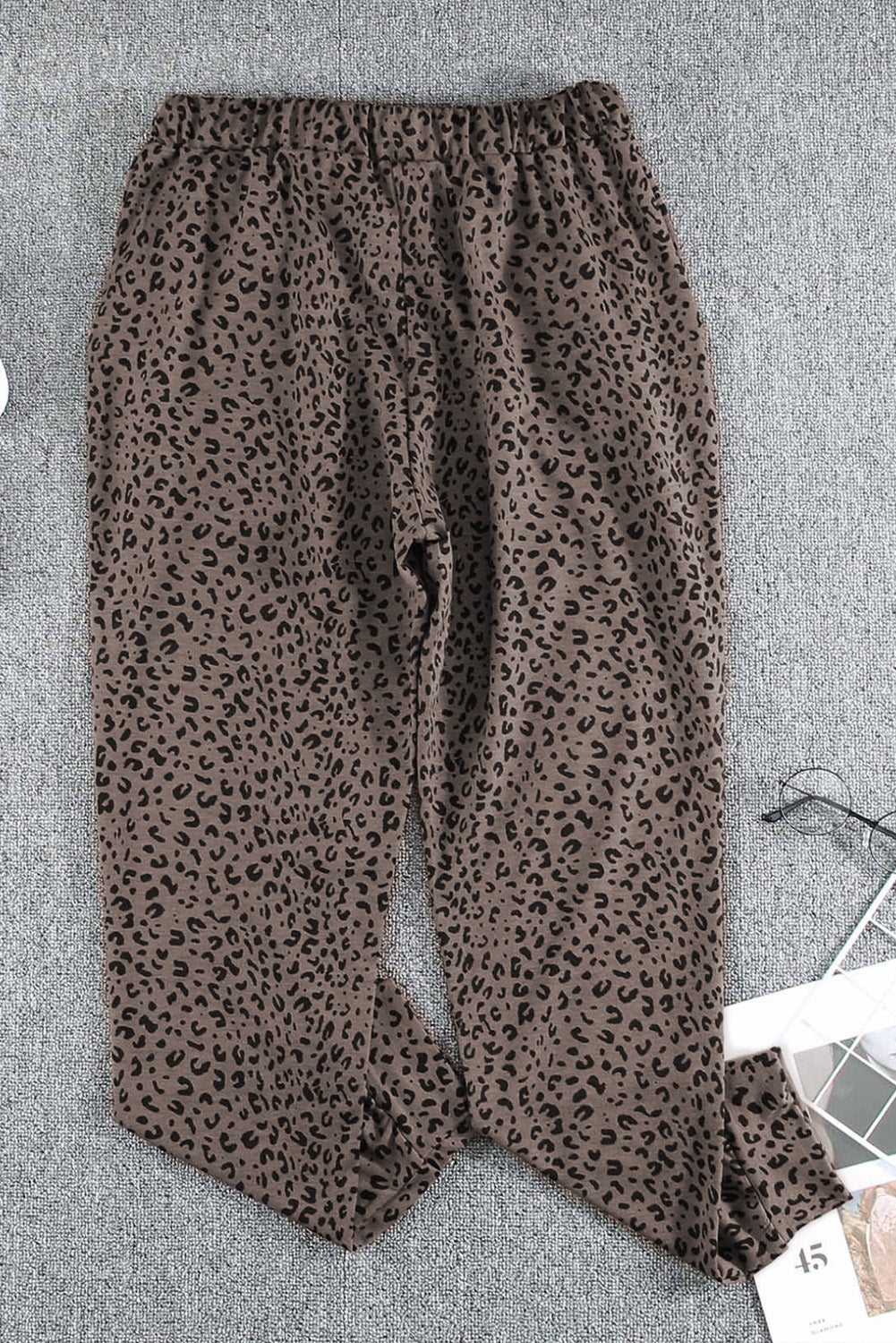 Black Breezy Leopard Joggers featuring a stylish leopard print and adjustable smocked waist, perfect for casual wear.