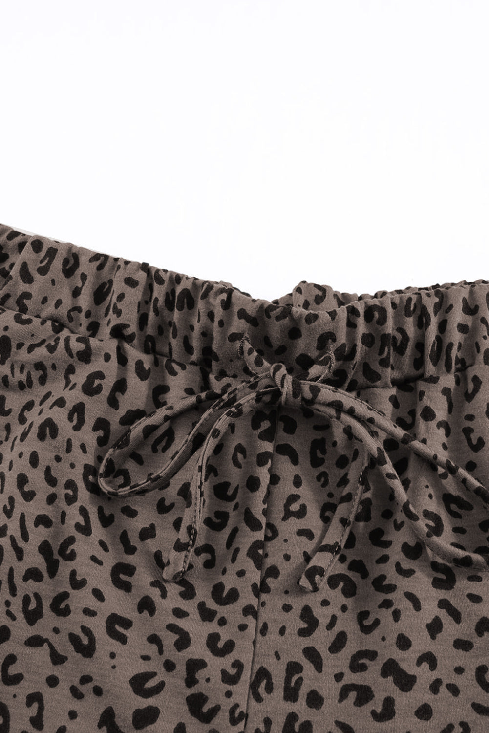 Black Breezy Leopard Joggers featuring a stylish leopard print and adjustable smocked waist, perfect for casual wear.