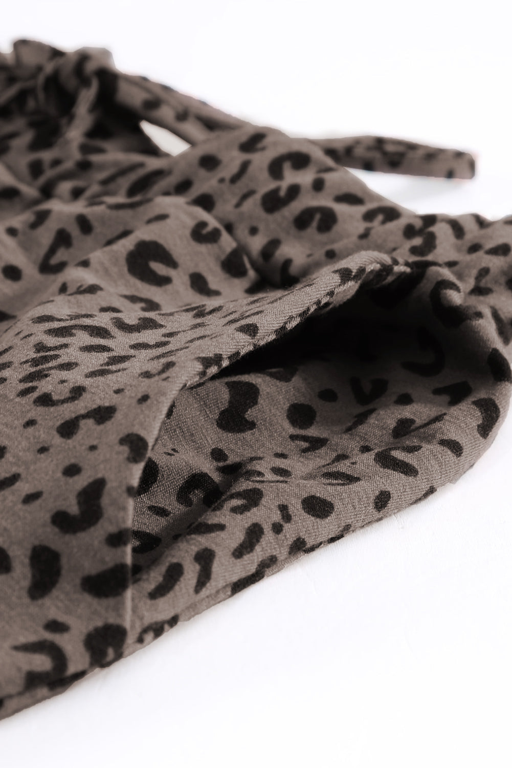 Black Breezy Leopard Joggers featuring a stylish leopard print and adjustable smocked waist, perfect for casual wear.