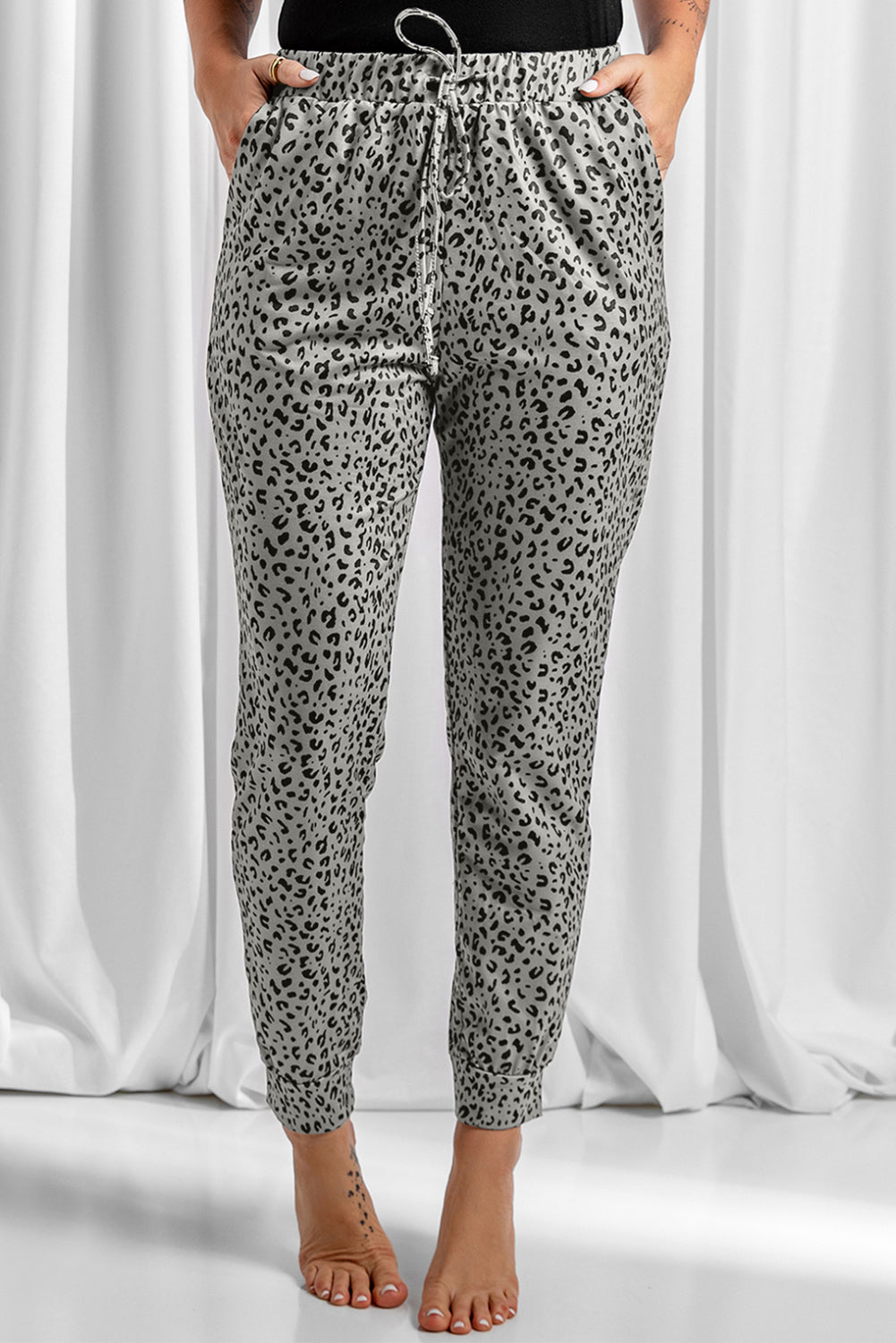 Black Breezy Leopard Joggers featuring a stylish leopard print and adjustable smocked waist, perfect for casual wear.