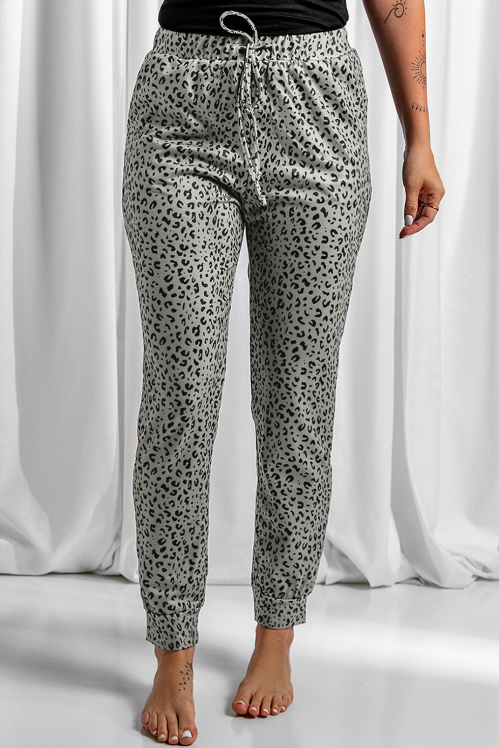 Black Breezy Leopard Joggers featuring a stylish leopard print and adjustable smocked waist, perfect for casual wear.