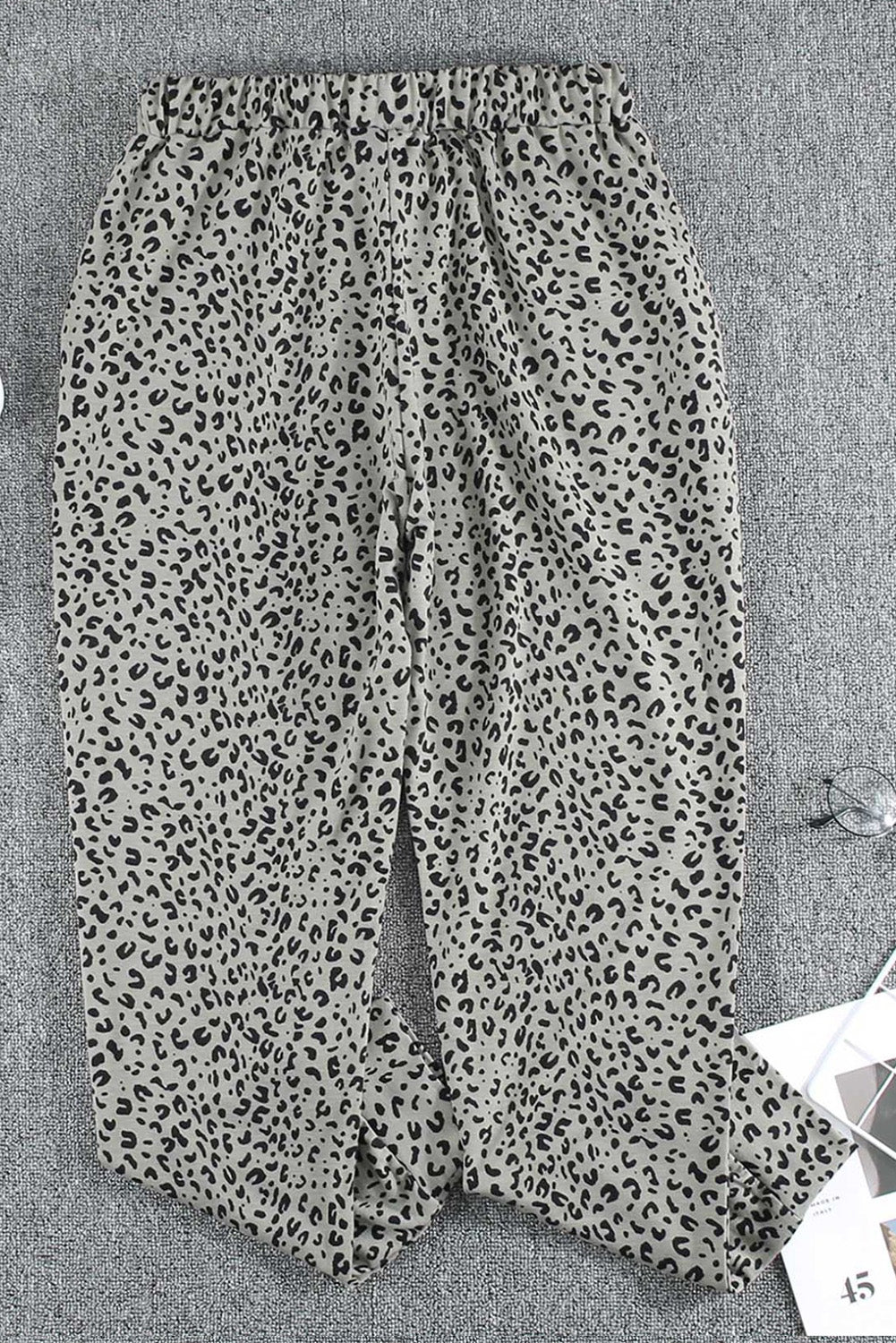 Black Breezy Leopard Joggers featuring a stylish leopard print and adjustable smocked waist, perfect for casual wear.