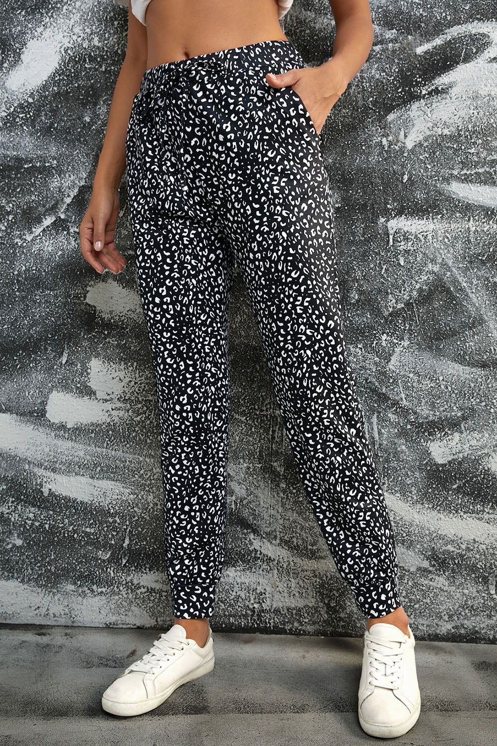 Black Breezy Leopard Joggers featuring a stylish leopard print and adjustable smocked waist, perfect for casual wear.