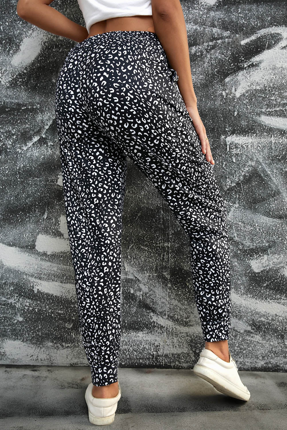 Black Breezy Leopard Joggers featuring a stylish leopard print and adjustable smocked waist, perfect for casual wear.