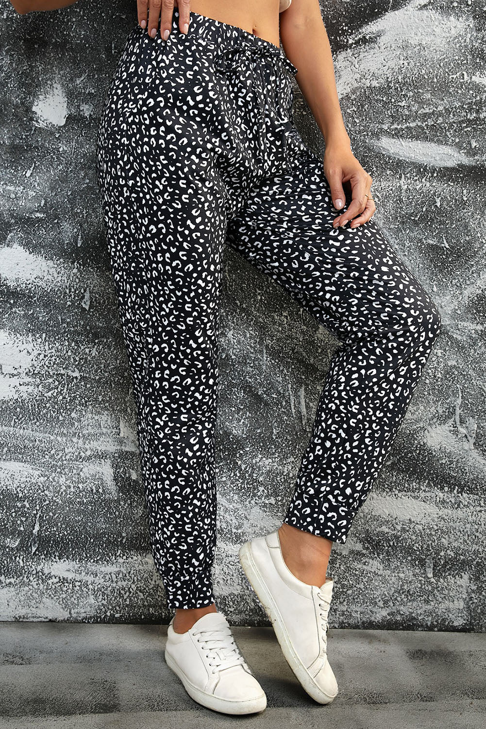 Black Breezy Leopard Joggers featuring a stylish leopard print and adjustable smocked waist, perfect for casual wear.