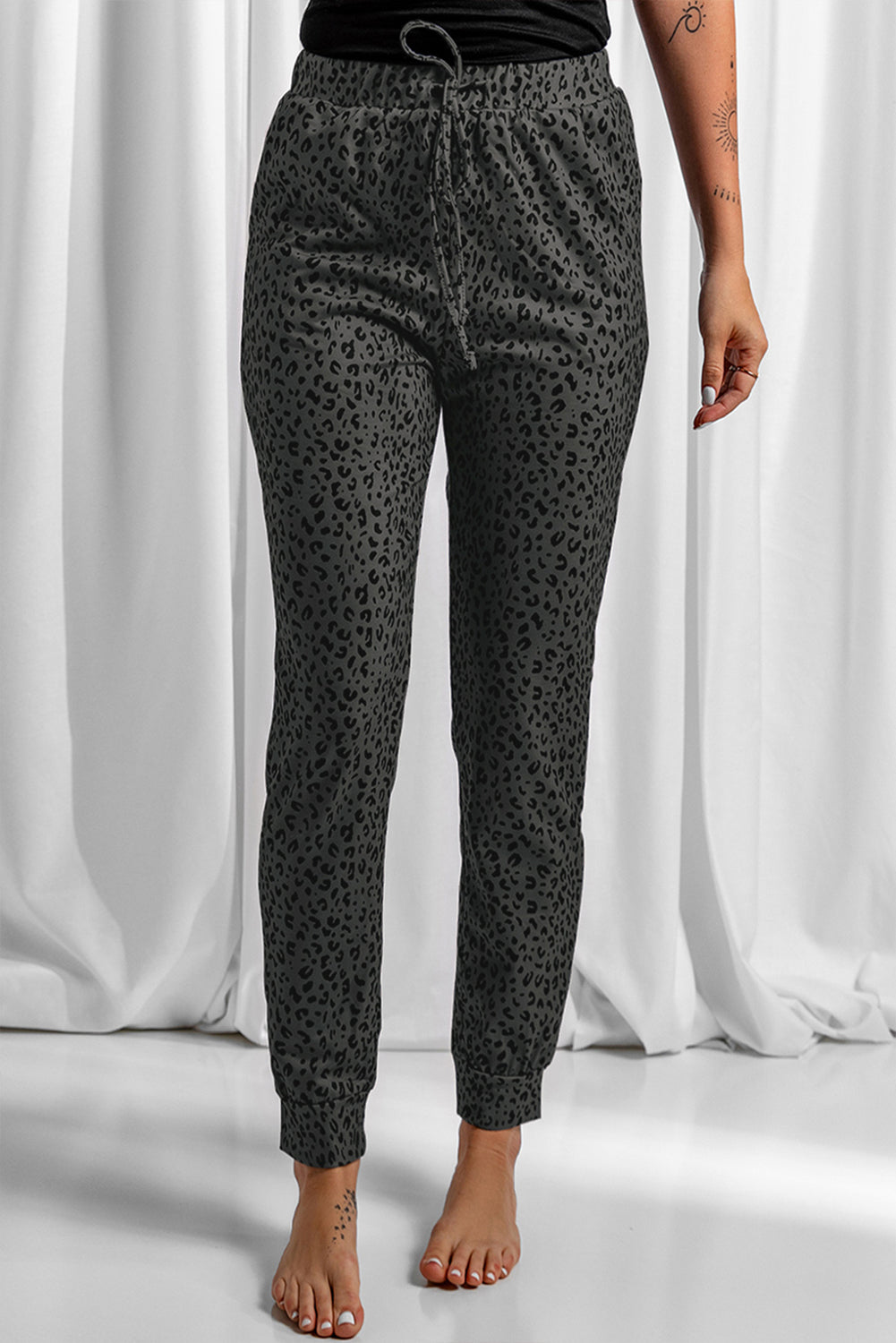 Black Breezy Leopard Joggers featuring a stylish leopard print and adjustable smocked waist, perfect for casual wear.