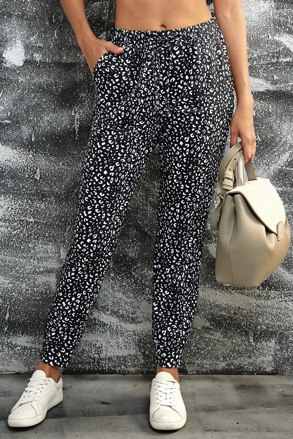 Black Breezy Leopard Joggers featuring a stylish leopard print and adjustable smocked waist, perfect for casual wear.