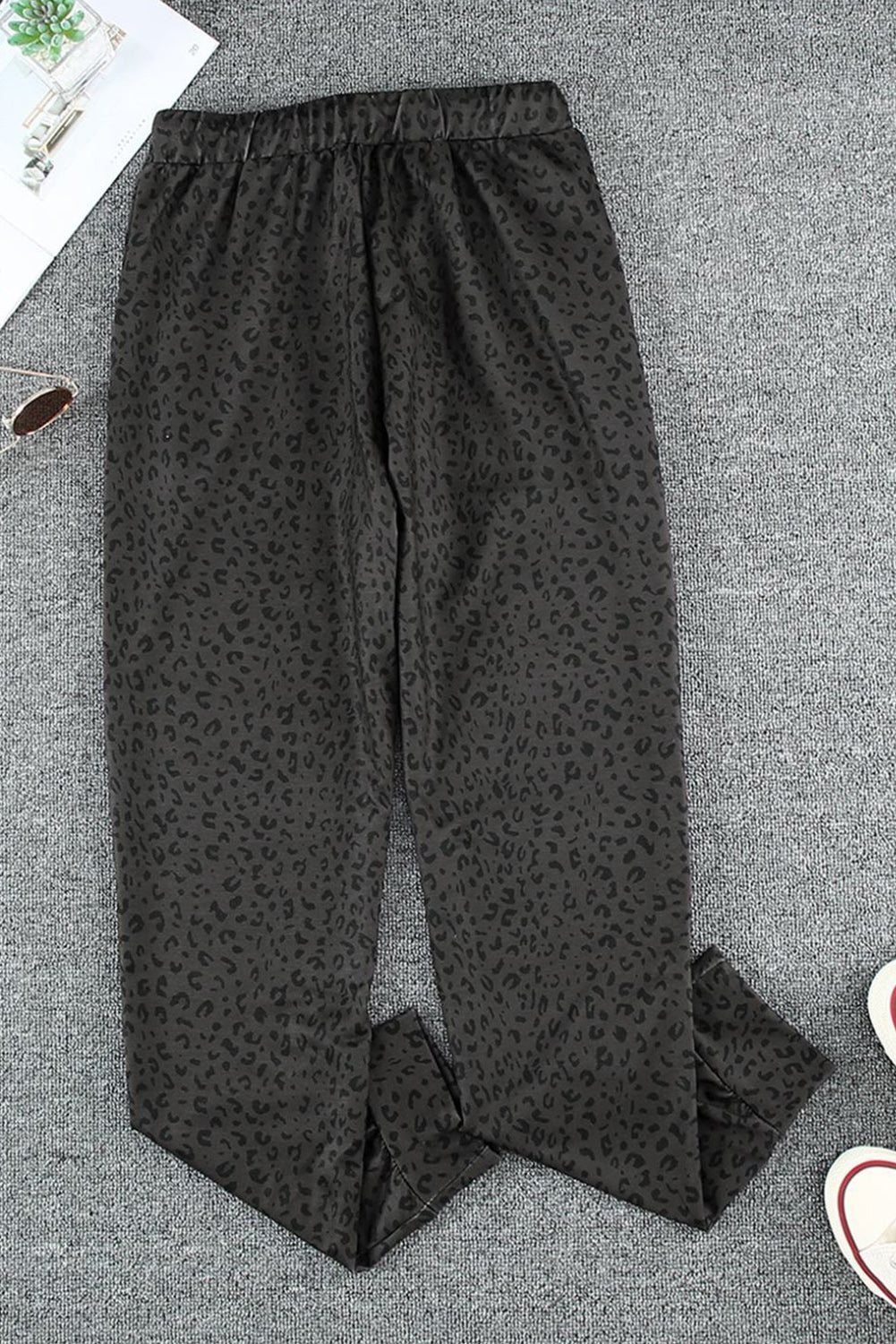 Black Breezy Leopard Joggers featuring a stylish leopard print and adjustable smocked waist, perfect for casual wear.