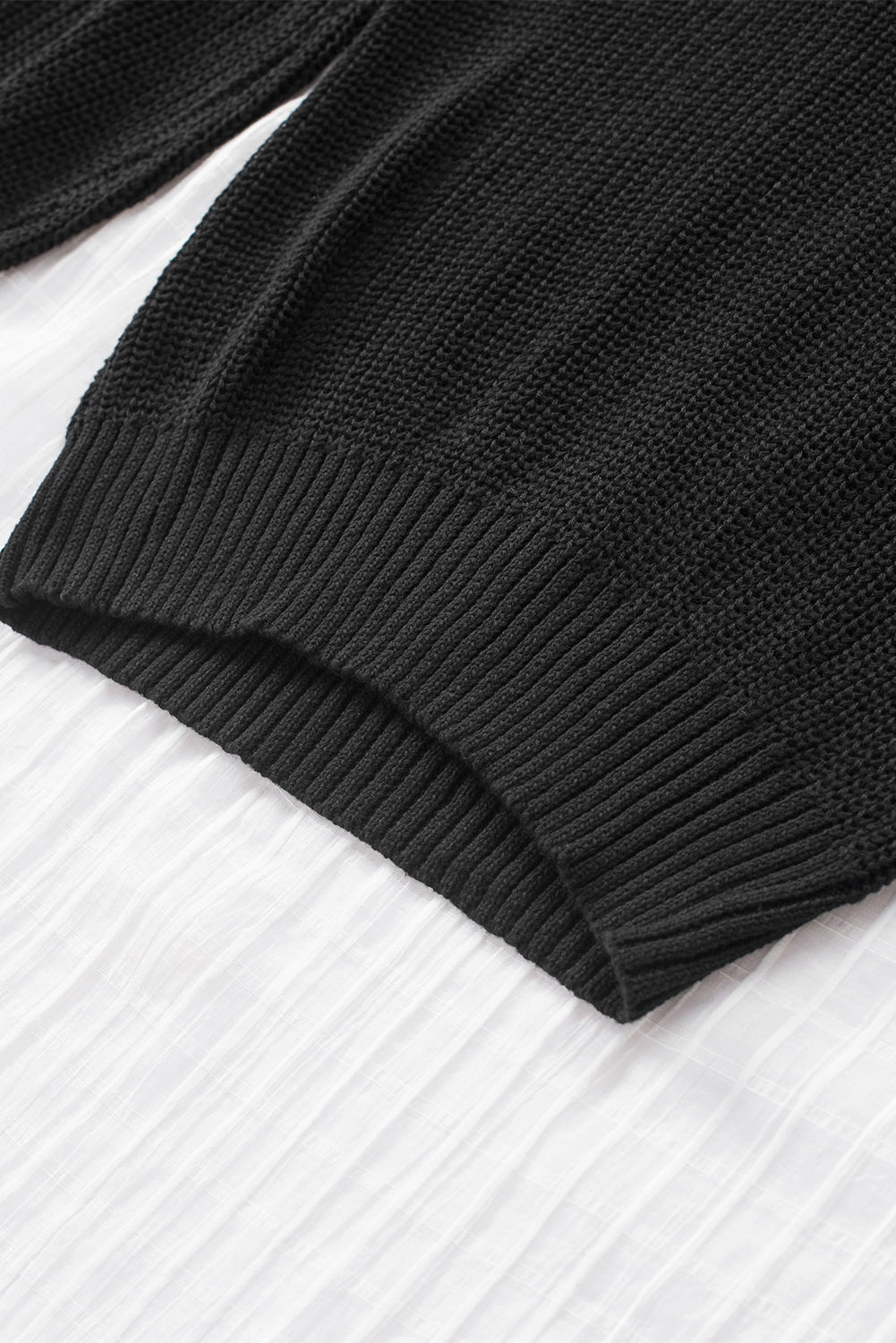 A stylish black casual loose halter neck sweater featuring cold shoulder cutouts and ribbed knit fabric, perfect for versatile styling.