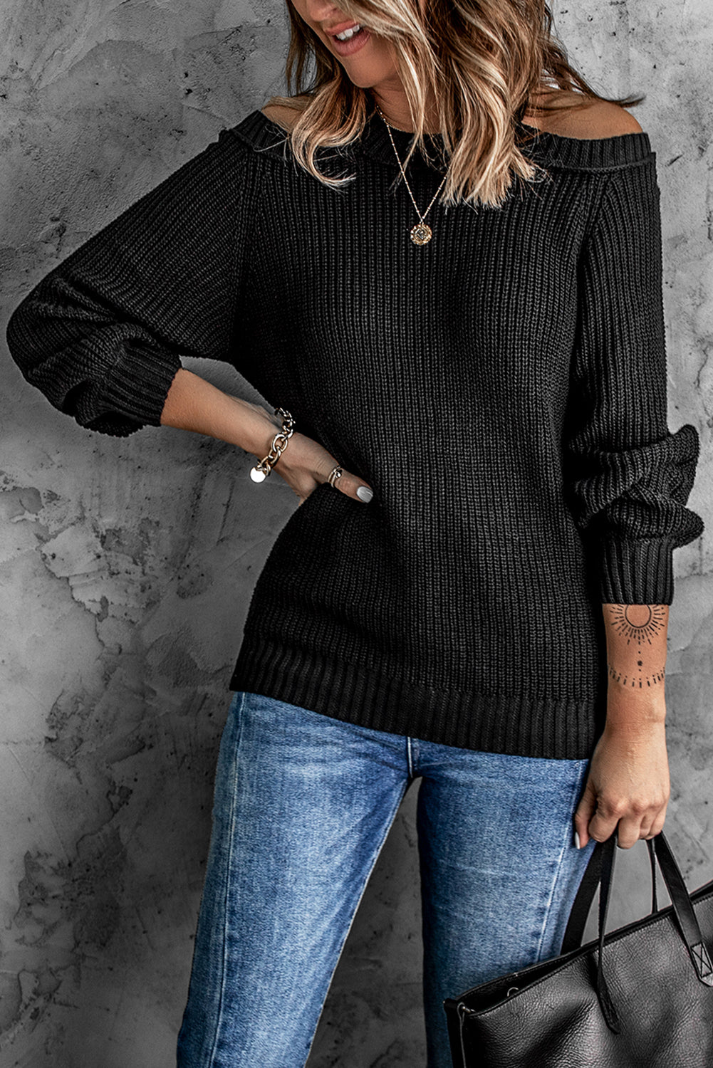 A stylish black casual loose halter neck sweater featuring cold shoulder cutouts and ribbed knit fabric, perfect for versatile styling.