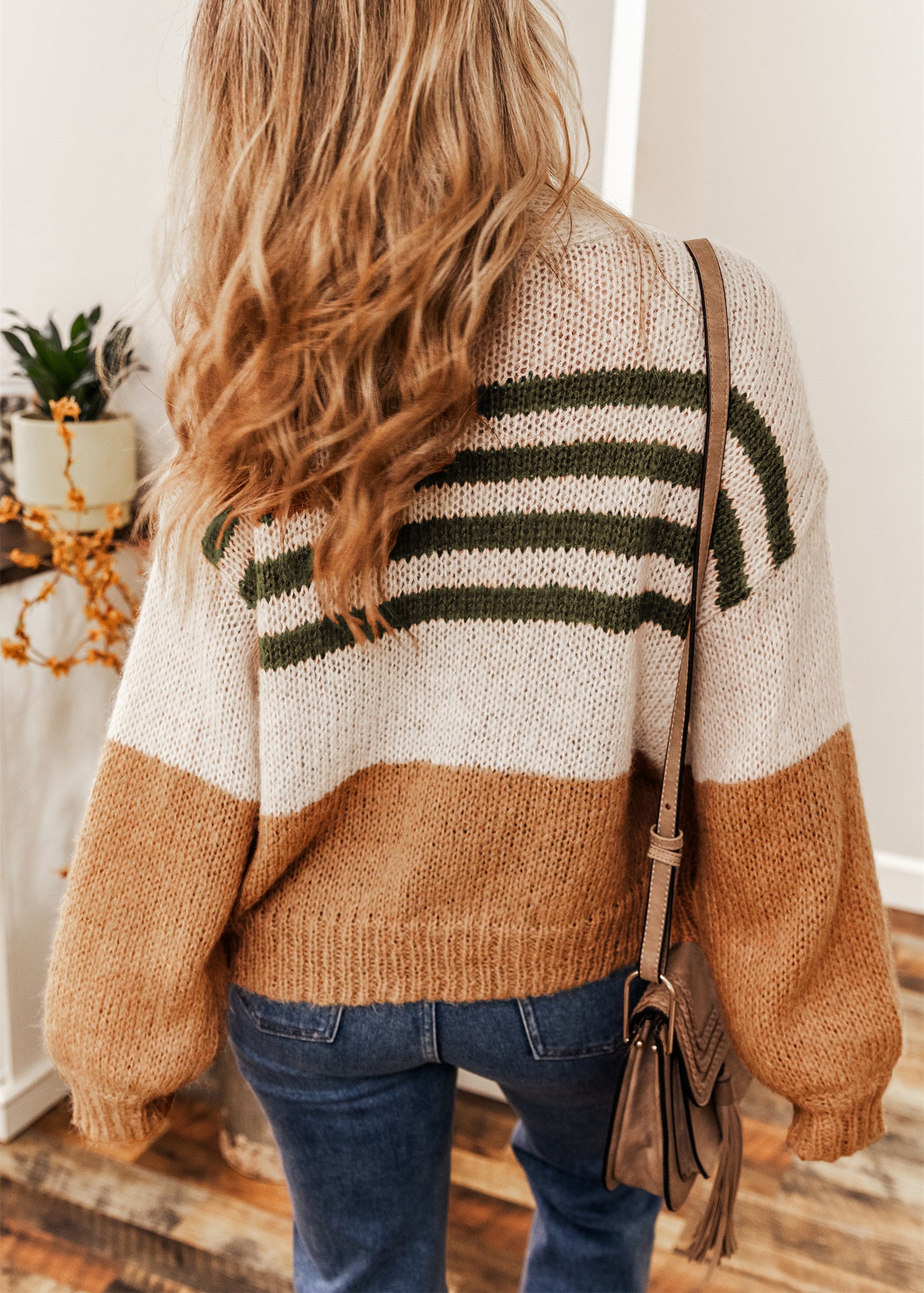 A stylish black colorblock striped open cardigan, featuring a chic design perfect for winter layering.