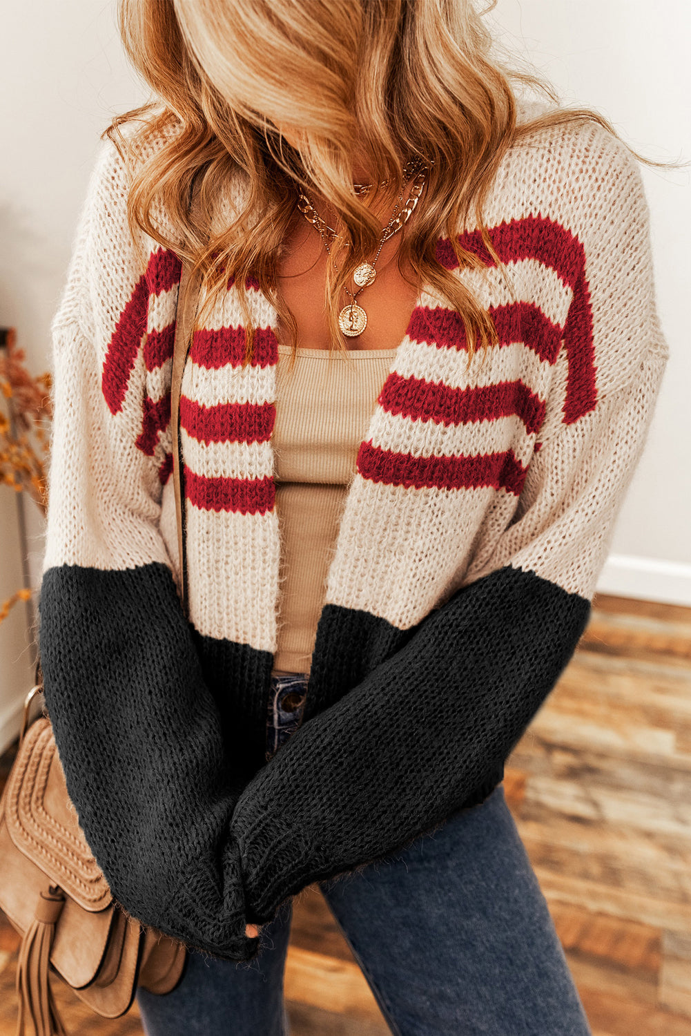 A stylish black colorblock striped open cardigan, featuring a chic design perfect for winter layering.