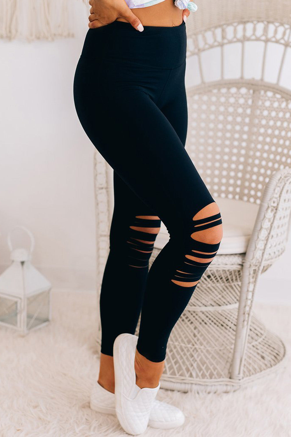 Black cut-out skinny high waist leggings showcasing a trendy design and high elastic material, perfect for stylish women.