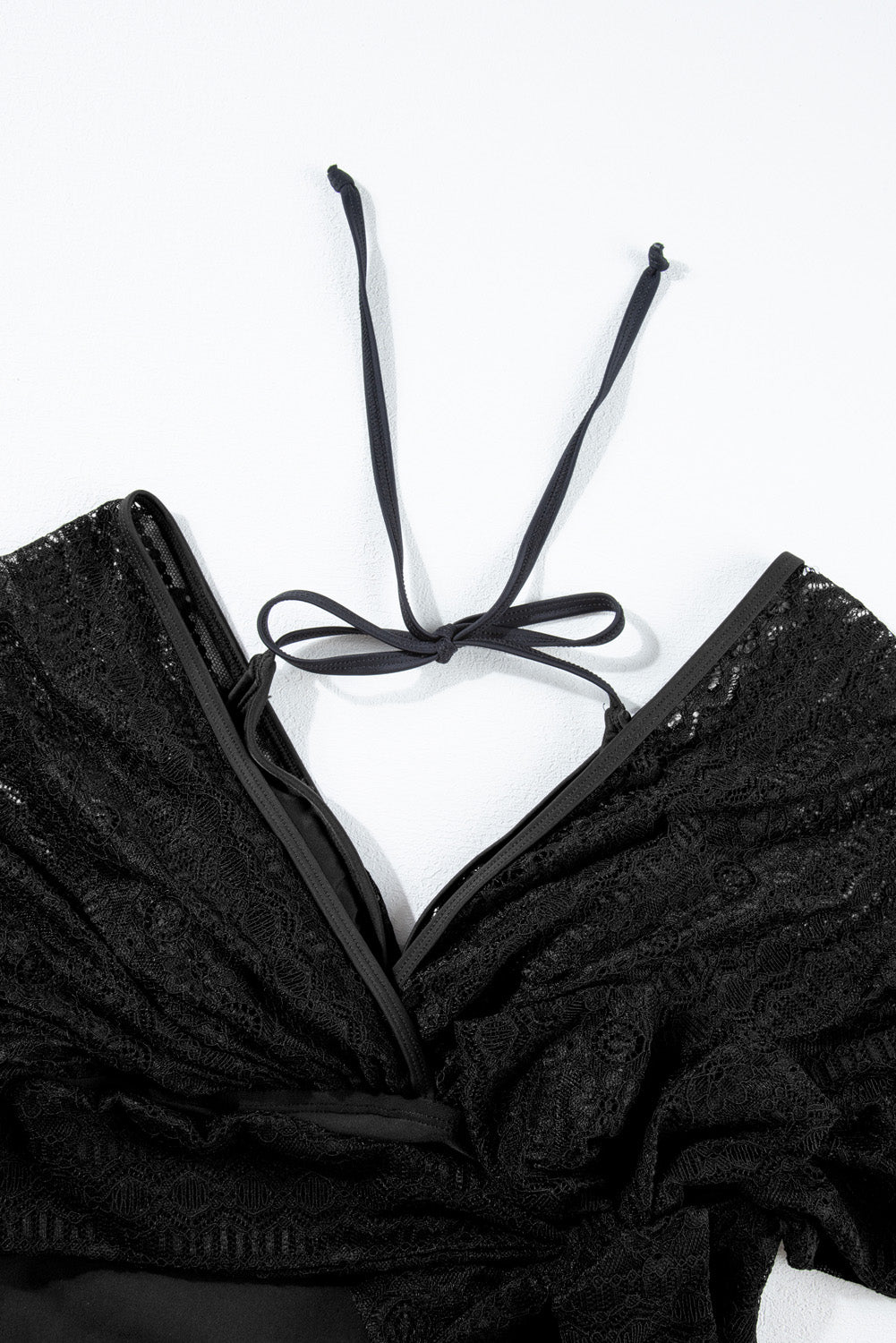 Black Lace Patchwork Short Sleeve Surplice Neck Monokini showcasing elegant lace design and flattering fit.