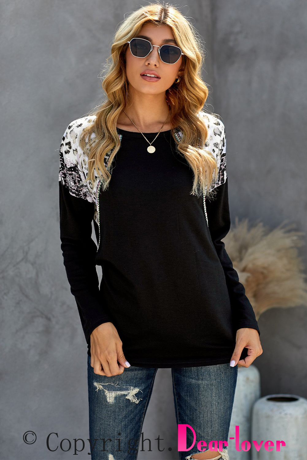 Black long sleeve top featuring a leopard snakeskin print, showcasing its stylish design and comfortable fabric.