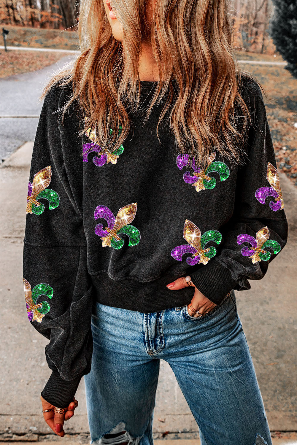 Black sweatshirt featuring a sequin Fleur De Lis design and an open back, perfect for Mardi Gras celebrations.