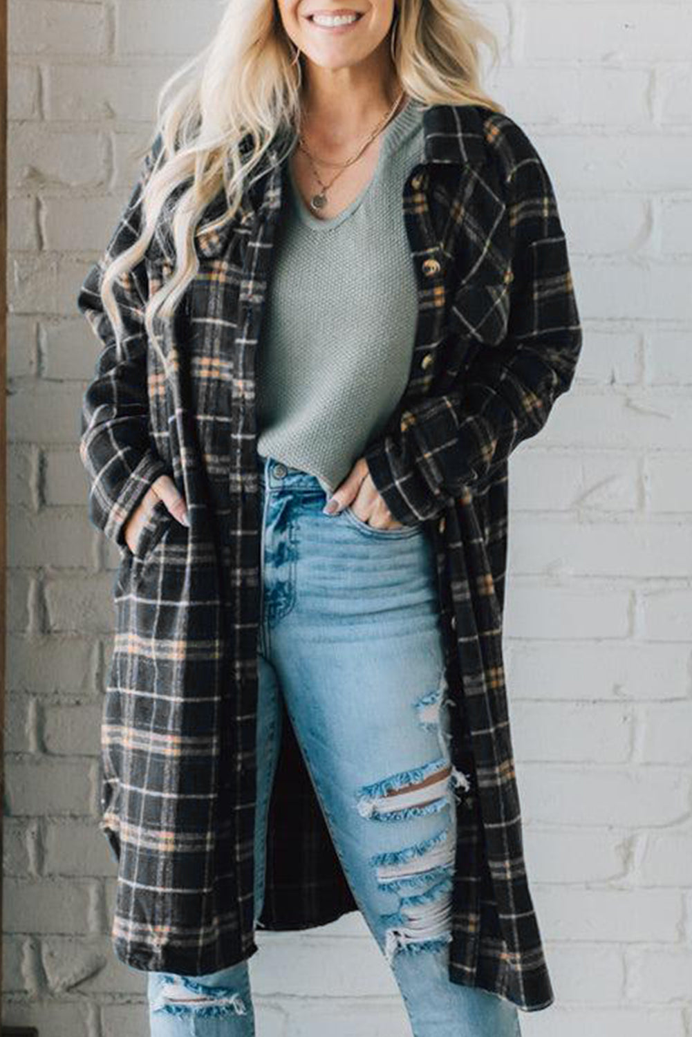 A stylish black plaid long shacket with button front and side pockets, perfect for layering and casual wear.