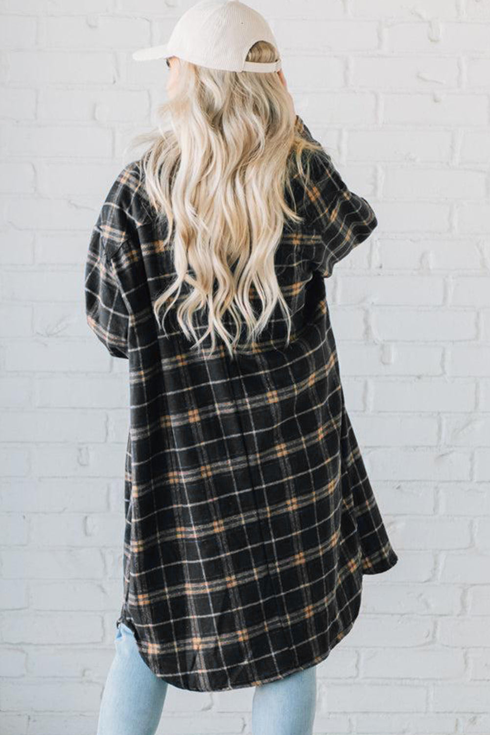 A stylish black plaid long shacket with button front and side pockets, perfect for layering and casual wear.