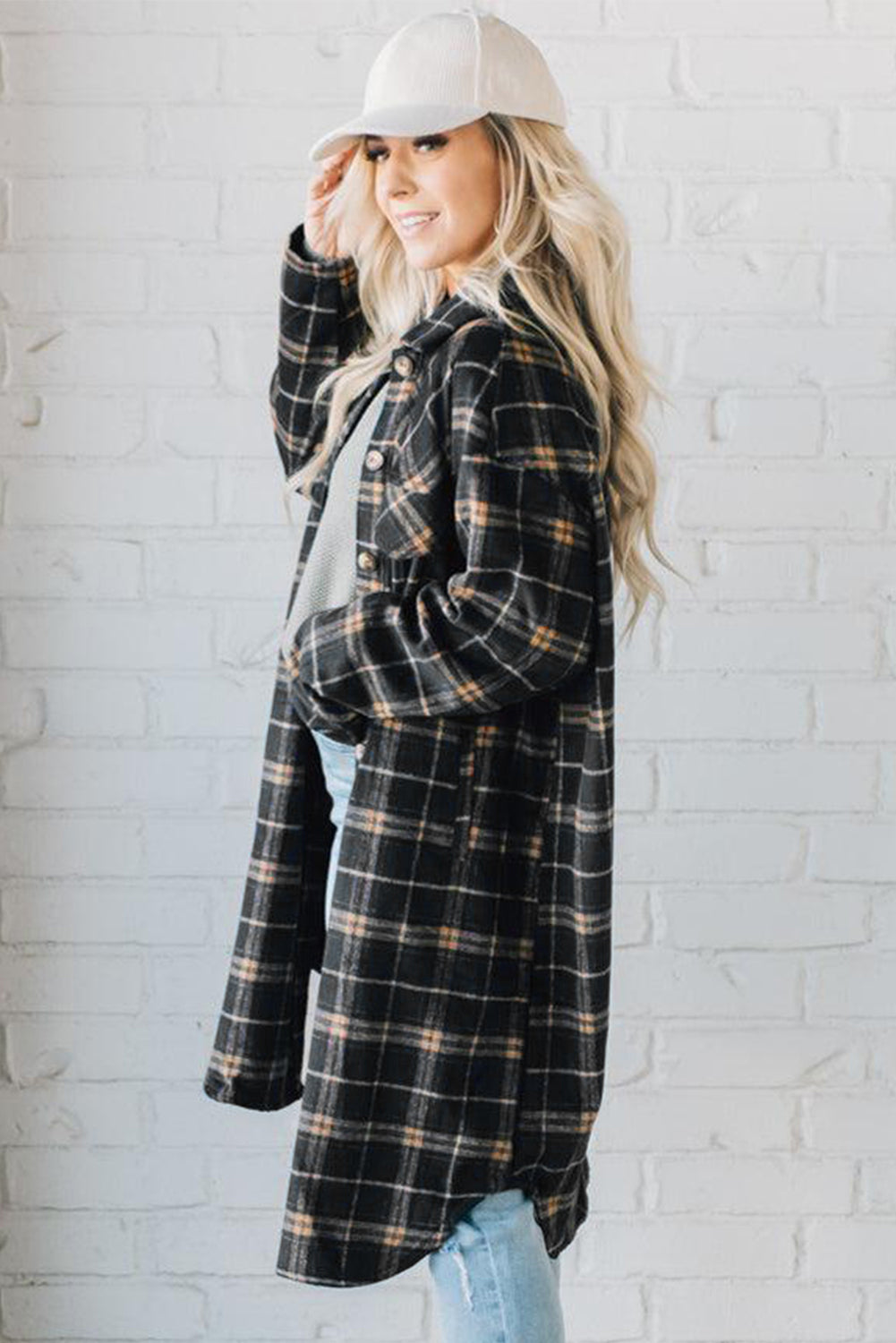 A stylish black plaid long shacket with button front and side pockets, perfect for layering and casual wear.