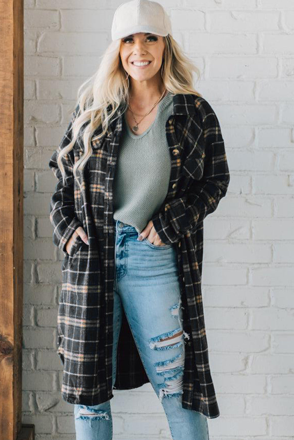 A stylish black plaid long shacket with button front and side pockets, perfect for layering and casual wear.