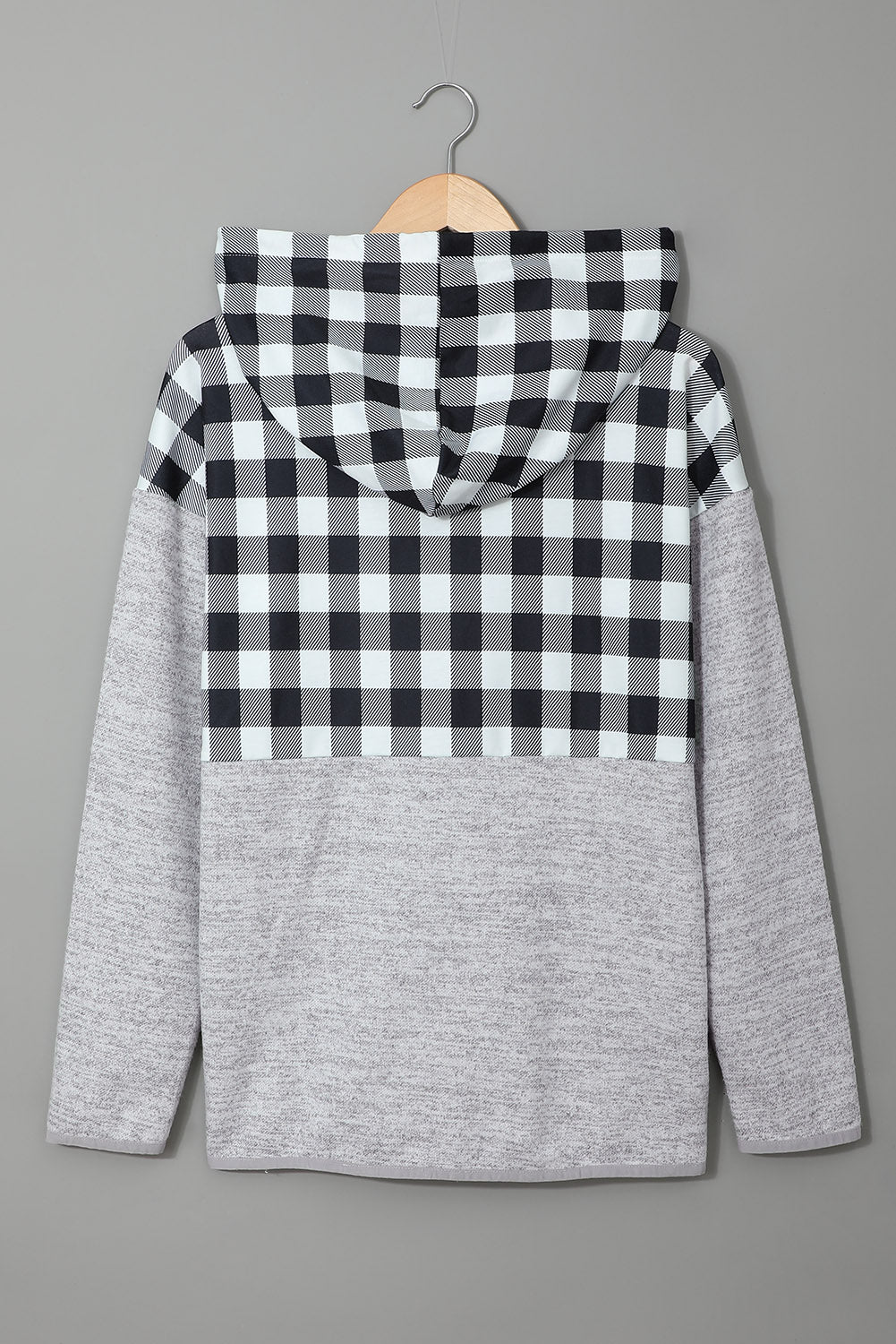 Black plaid splicing pocketed hoodie featuring a loose design and buttoned neckline, perfect for autumn wear.