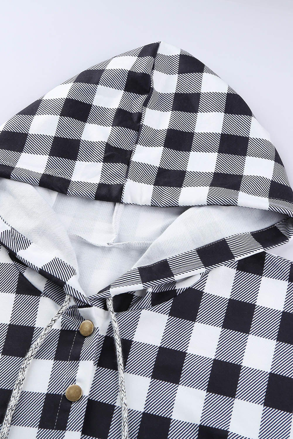 Black plaid splicing pocketed hoodie featuring a loose design and buttoned neckline, perfect for autumn wear.