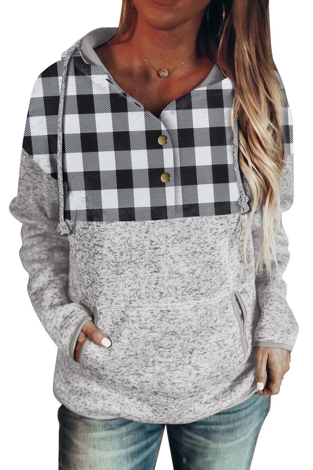 Black plaid splicing pocketed hoodie featuring a loose design and buttoned neckline, perfect for autumn wear.