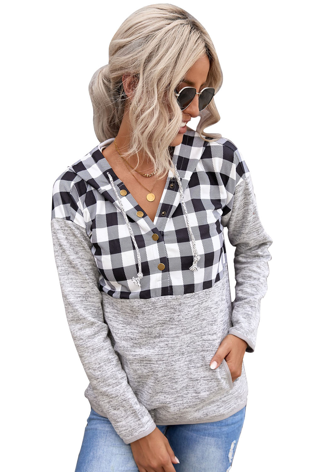 Black plaid splicing pocketed hoodie featuring a loose design and buttoned neckline, perfect for autumn wear.