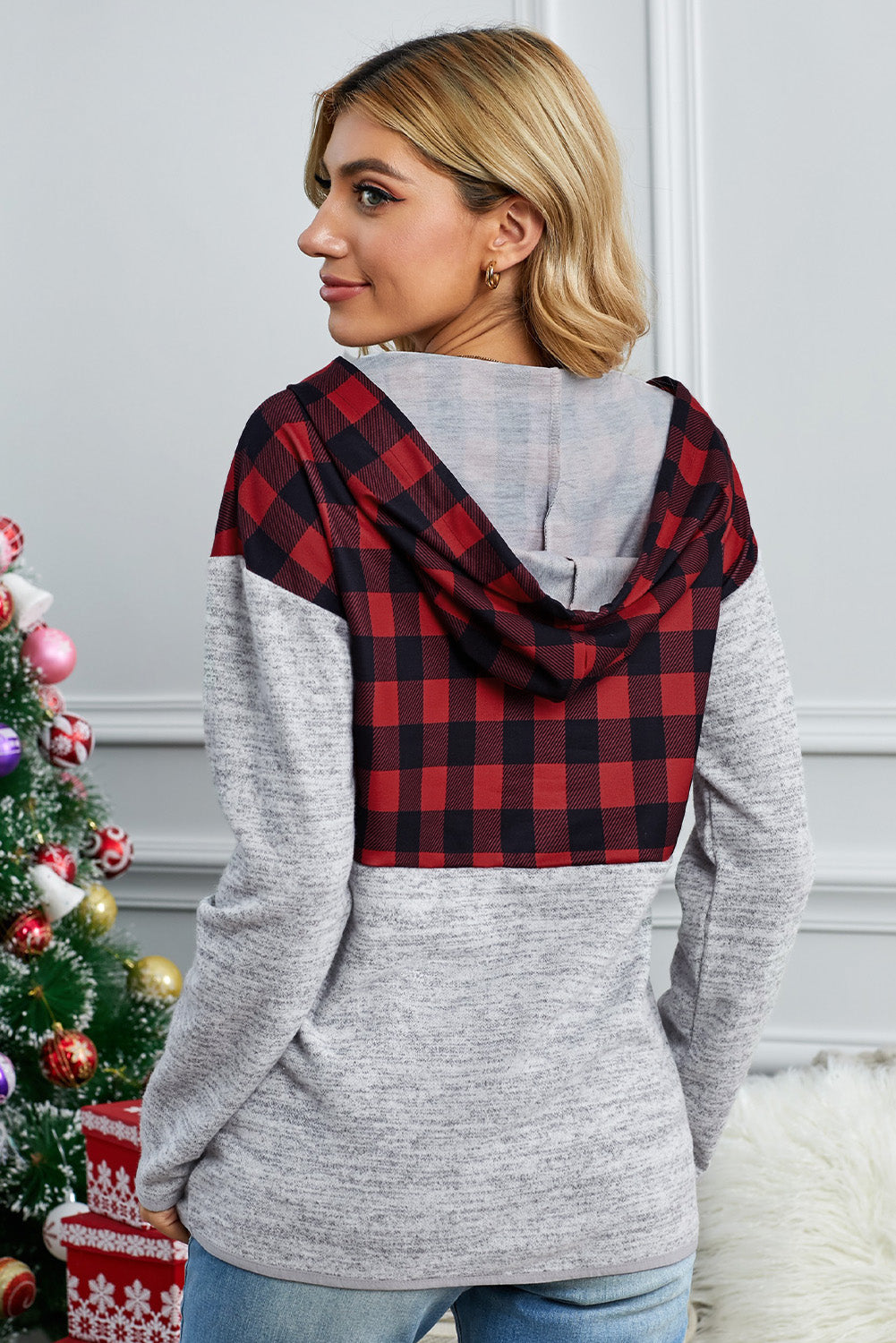 Black plaid splicing pocketed hoodie featuring a loose design and buttoned neckline, perfect for autumn wear.