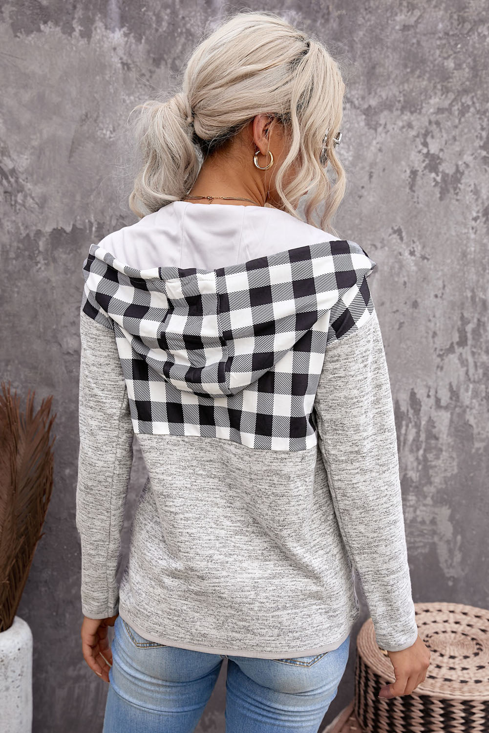 Black plaid splicing pocketed hoodie featuring a loose design and buttoned neckline, perfect for autumn wear.