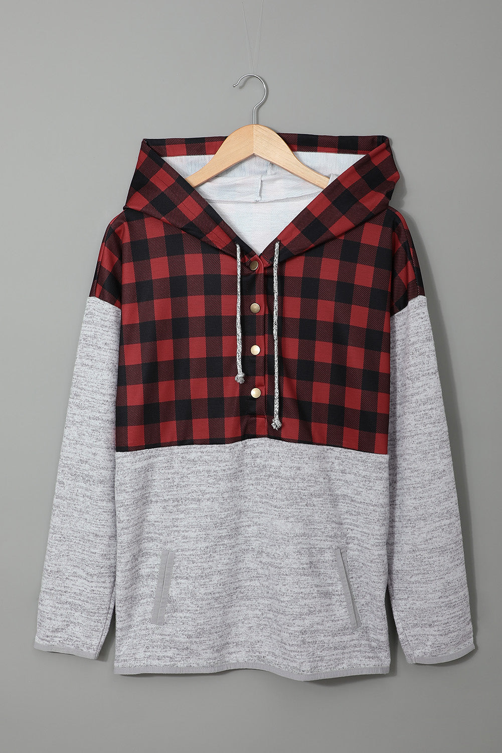 Black plaid splicing pocketed hoodie featuring a loose design and buttoned neckline, perfect for autumn wear.