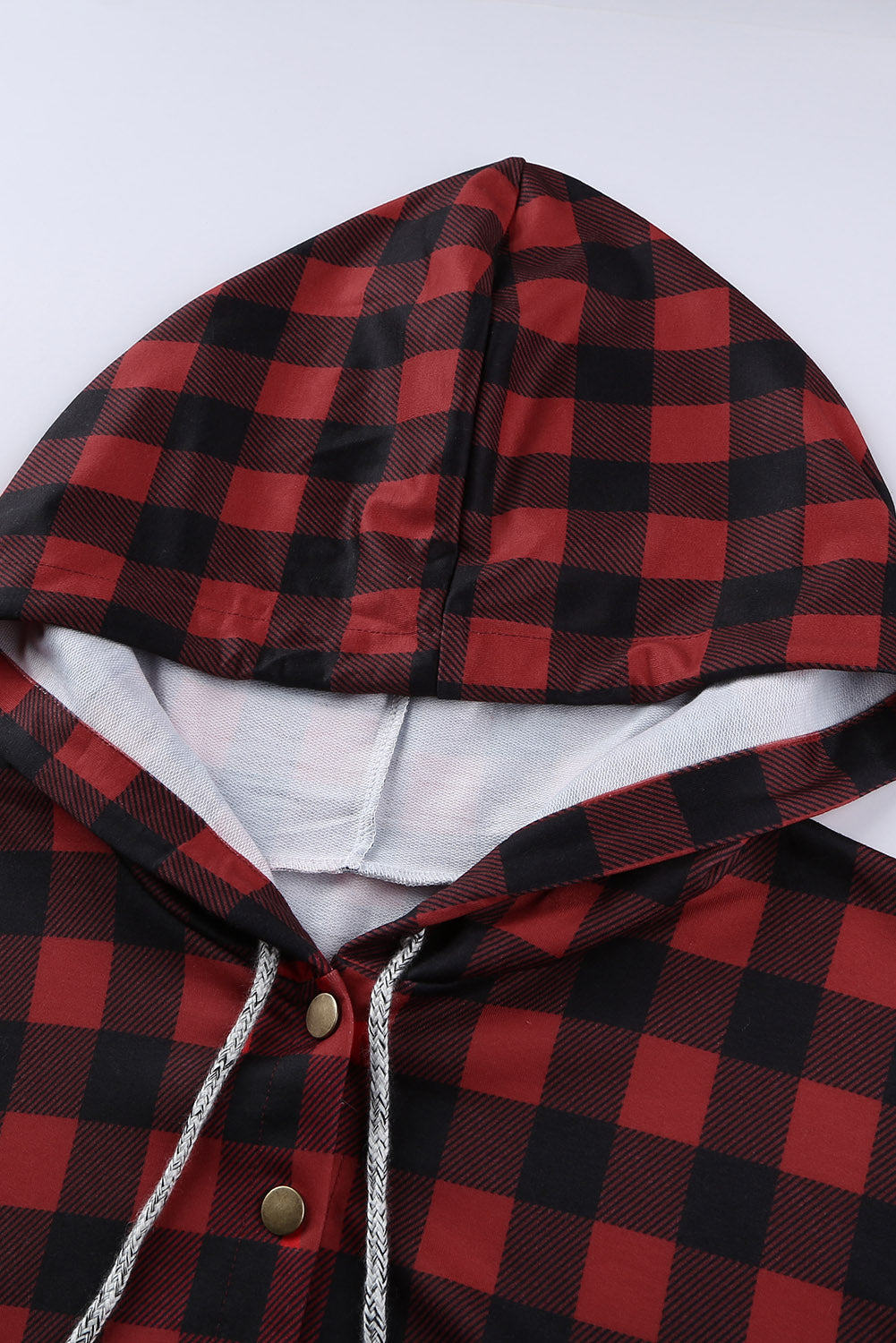 Black plaid splicing pocketed hoodie featuring a loose design and buttoned neckline, perfect for autumn wear.