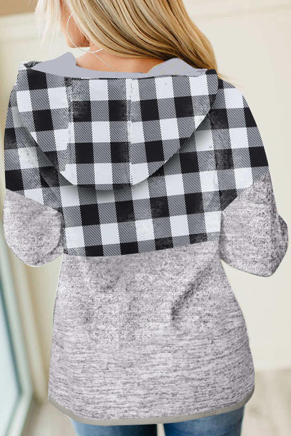 Black plaid splicing pocketed hoodie featuring a loose design and buttoned neckline, perfect for autumn wear.